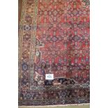 A fine Hamadan (Persian) carpet central motif and patterned on claret ground. No damage
