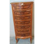 A vintage French walnut and tulipwood serpentine front tall chest of seven drawers with marquetry