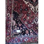 A quality Bakhtiar carpet. A central diamond medallion on a burnt amber field. 3.10m x 2.15m