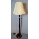 A vintage fruitwood standard lamp with barley twist column raised on a plinth base. Condition