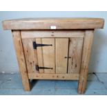 A small vintage pine butcher?s block with integral storage cupboard, raised on square supports.