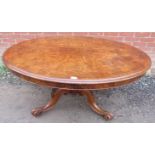 A Victorian walnut oval tilt top loo table, the quarter veneered top raised on a bulbous octagonal