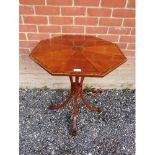 A decorative walnut octagonal side table in the Regency taste, strung with satinwood and crossbanded