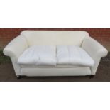 A turn of the century two-seater sofa, reupholstered to a high standard to calico level, with two