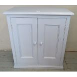 A vintage pine side cupboard painted duck egg blue, with internal fitted shelf, raised on a plinth