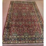 A Persian Kashan carpet repeat pattern blue on red ground. In good clean condition and colour good