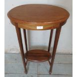 An Edwardian mahogany oval occasional table strung with satinwood, raised on tapering square