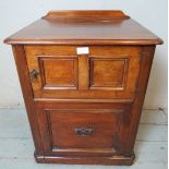 A late Victorian mahogany commode with single cupboard over a base drawer containing original