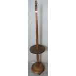 A vintage fruitwood standard lamp with table, featuring applied gilt metal foliate detail, raised on