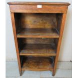 A vintage diminutive oak open bookcase of three shelves, raised on tapering block feet. Condition