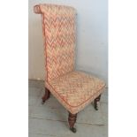 A 19th century prie-dieu chair upholstered in contemporary multicoloured fabric, raised on turned