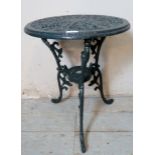 A small vintage cast iron occasional garden table painted forest green, raised on splayed