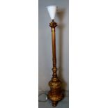 A very ornate giltwood standard lamp in the Regency taste, with reeded column, raised on a heavy