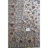 A good Persian Kashan carpet with a central pattern motif on a cream ground in good condition and