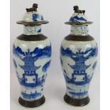 A pair of antique Chinese porcelain covered jars hand decorated and with a crackle glaze finish.