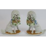 A pair of antique continental porcelain poodles with baskets, both with incised mark 2505. Height: