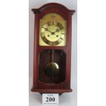 A modern striking wall clock in mahogany case with gilt brass dial. Height 60cm. No key. Condition