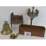 A bronze bell, copper flower trough, brass fruit inkwell, cast iron welcome sign and a Gothic