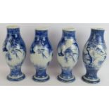 Four similar Japanese porcelain vases hand decorated with birds in trees, all signed to bases.