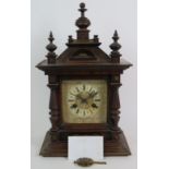 A late 19th Century Junghans oak cased striking mantel clock in the Gothic style. The ornate case