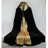 A rare black velvet opera cape with swan down feather collar and silk lining. Length 130cm.