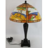 A contemporary Tiffany style table lamp with Clarice Cliff design panelled glass shade on a fluted