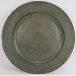 A large antique English pewter charger with touch marks to rim, maker TP. Diameter 52cm. Condition