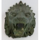 A finely cast antique bronze lion's head gargoyle, stamped 9. L. Height 23cm. Depth 17cm.