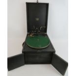 A HMV vintage wind up gramophone with opening speaker doors. Condition report: Needle head is