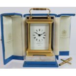 A Garrard & Co miniature brass cased 8 day carriage clock in bespoke leather case. Key present.