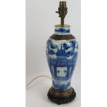 An antique Chinese porcelain vase hand decorated and with a crackle glaze finish mounted on a turned