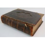 A late 19th/early 20th Century leather and gilt bound family bible with colour illustrations and