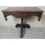 A 19th Century oak pedestal table, ornately carved in the Flemish taste, the foliate carved and