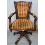 A good quality reproduction mahogany show-wood swivel and tilt desk chair, upholstered in a textured