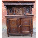 A large antique 17th century style oak court cupboard of three cupboards over one long drawer and
