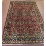 A Persian Kashan carpet repeat pattern blue on red ground. In good clean condition and colour