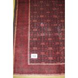 A meshed Belouch carpet repeat central pattern on deep burgundy ground. 280 x 160 Condition