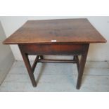 An early 18th century country made oak side table with single frieze drawer, on square supports with
