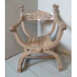 A 19th century beech Savonarala 'X' frame chair featuring lion mask finials, scroll carved & pierced