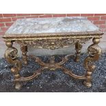 A vintage marble topped giltwood centre table in a Louis XIV style, on very ornate foliate carved