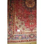 A fine Persian Tabriz carpet with central motif on claret ground. 3.18 x 2.00 Condition report: Very