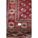 A fine Turkoman carpet with repeat central pattern on burgundy ground. 3.90 x 2.50 Condition report: