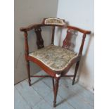 An Edwardian mahogany inlaid corner chair with lyre back & tapestry seat, raised on tapering