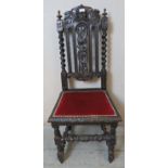 A Victorian Carolean-Revival carved oak dining chair.