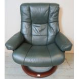 A mid green leather reclining ?Stressless? lounge chair by Ekornes, raised on a swivel circular base