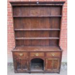 An 18th century oak kitchen dresser of good colour, with plate rack shelving over a sideboard base