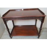 An Edwardian Chinese Chippendale revival mahogany two tier buffet/drinks table with ¾ gallery, blind