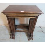 An Edwardian mahogany quartet of nesting tables raised on reed supports with openwork lattice side