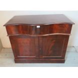 A 19th century flame mahogany serpentine fronted sideboard of small proportions with two blind