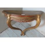 A vintage wall mounted demi lune table in the 19th century taste with carved floral frieze